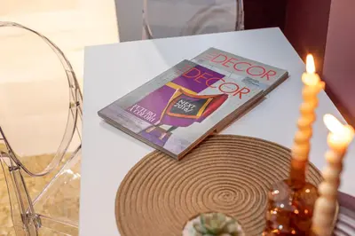 a magazine and a hat on a table with a candle at YCH-Cozy Flat at the Vatican in Rome