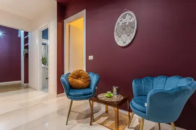 a living room with two blue chairs and a table at YCH-Cozy Flat at the Vatican in Rome