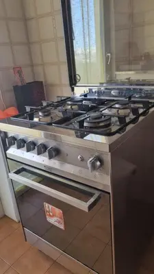 an oven with a stove top in a kitchen at Dreamy Family Getaway Guest House Roma 2BR,2BA in Rome