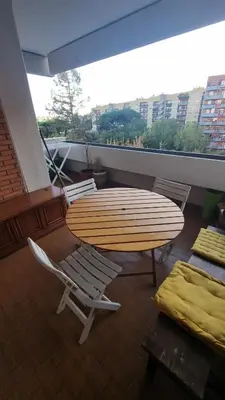 a table and chairs on a balcony with a surfboard at Dreamy Family Getaway Guest House Roma 2BR,2BA in Rome