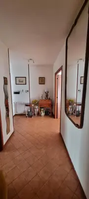 a living room with a couch and a mirror at Dreamy Family Getaway Guest House Roma 2BR,2BA in Rome