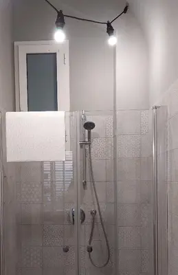 a bathroom with a shower with a glass door at Afnakafna Home in Rome