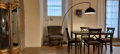 a dining room with a table and chairs and a lamp at Afnakafna Home in Rome