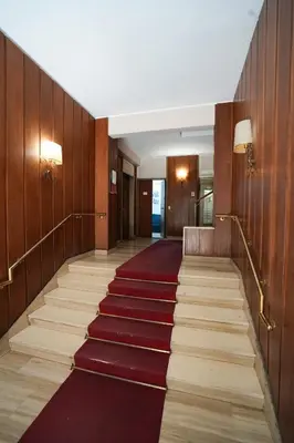 a hallway with a red carpet in a building at House Appio Latino Roma in Rome