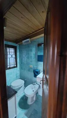 a bathroom with two toilets and a sink at Chalet dei Girasoli in Rome