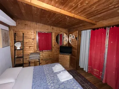 a bedroom with a bed in a wooden cabin at Chalet dei Girasoli in Rome