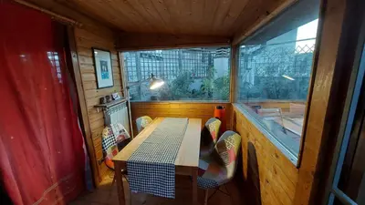 a small dining room with a table and a window at Chalet dei Girasoli in Rome
