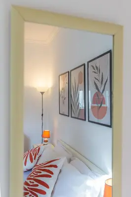 a bedroom with a bed with four pictures on the wall at Milvio Bridge - Olympic Stadium, Farnesina, A-C in Rome