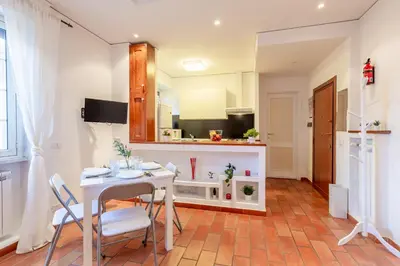 a kitchen with a table and chairs and a counter at Milvio Bridge - Olympic Stadium, Farnesina, A-C in Rome