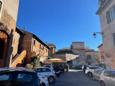 a group of cars parked on a street with buildings at STUDIO4 ROMA in Rome
