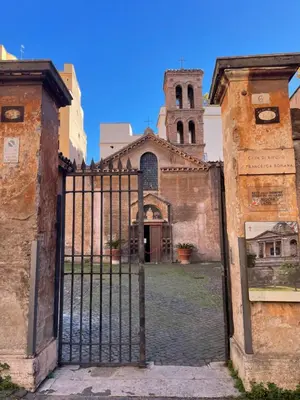 an old gate with a church behind it at STUDIO4 ROMA in Rome