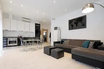 a living room and kitchen with a couch and a table at Piramide - Charme Apartment in Rome