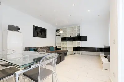 a living room with a glass table and a couch at Piramide - Charme Apartment in Rome