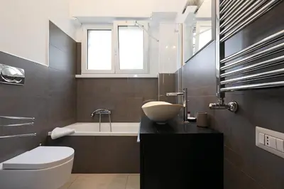 a bathroom with a sink and a toilet and a tub at Piramide - Charme Apartment in Rome