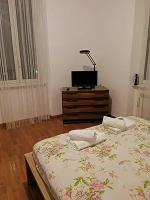 a bedroom with a bed and a tv on a dresser at La Casetta di Benedetta in Rome