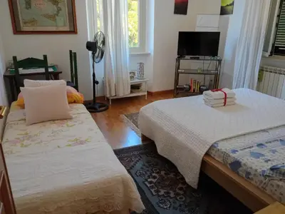 a room with two beds and a television in it at La Casetta di Benedetta in Rome