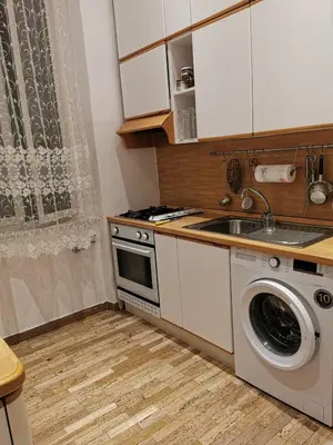 a kitchen with a washing machine and a sink at La Casetta di Benedetta in Rome