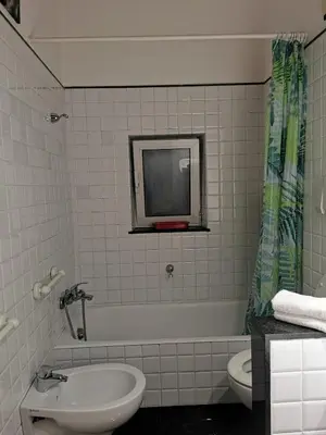 a bathroom with a sink and a toilet and a tv at La Casetta di Benedetta in Rome
