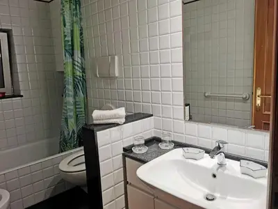 a bathroom with a sink and a toilet and a mirror at La Casetta di Benedetta in Rome