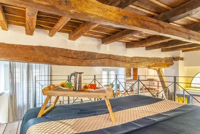 a room with a bed and a table in a room at L'antico borgo di Trastevere III in Rome