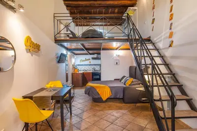 a bedroom with a bunk bed and a spiral staircase at L'antico borgo di Trastevere III in Rome