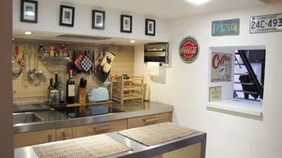a kitchen with a sink and a counter with wine bottles at HT Loft Testaccio in Rome