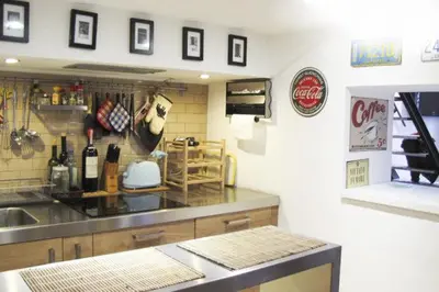 a kitchen with a counter with bottles of wine at HT Loft Testaccio in Rome