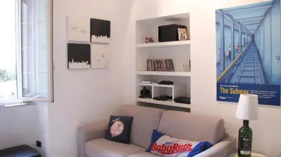 a living room with a couch and a staircase at HT Loft Testaccio in Rome