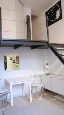a room with a table and chairs and a loft at HT Loft Testaccio in Rome