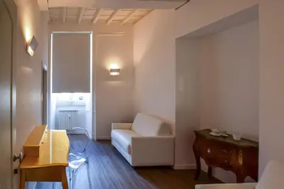 a living room with a white couch and a table at Navona Secret Stay Guest House in Rome
