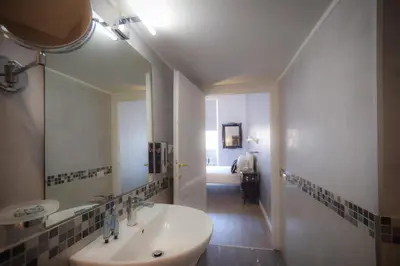 a bathroom with a sink and a mirror at Navona Secret Stay Guest House in Rome