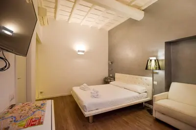 a small room with a bed and a couch at Navona Secret Stay Guest House in Rome