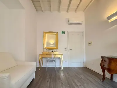 a living room with a table and a couch at Navona Secret Stay Guest House in Rome