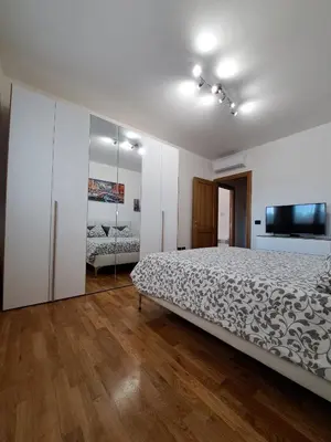 a bedroom with a bed and a flat screen tv at Angy's house Roma in Rome