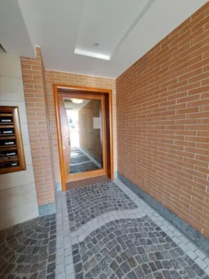 a hallway with a brick wall and a mirror at Angy's house Roma in Rome