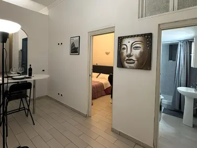 a room with a bedroom with a face on the wall at Cairoli 2 House G&B Termini in Rome