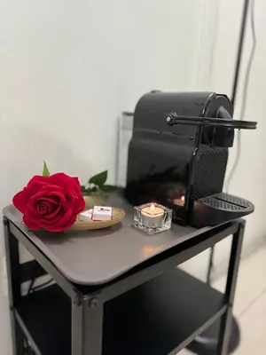 a red rose sitting on a table next to a toaster at Cairoli 2 House G&B Termini in Rome
