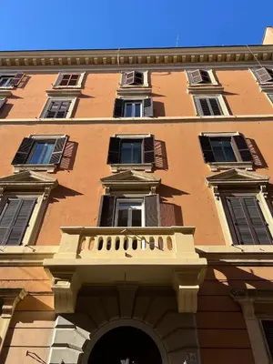 a tall building with a balcony on the side of it at Cairoli 2 House G&B Termini in Rome