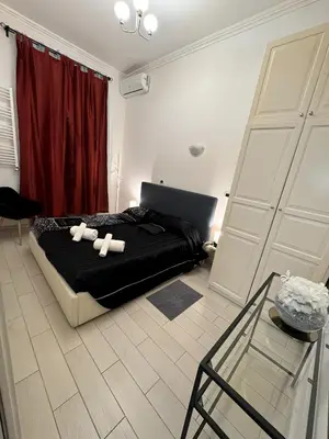 a bedroom with a bed and a laptop on it at Cairoli 2 House G&B Termini in Rome