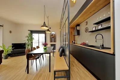a kitchen and living room with a table and chairs at YCH-Trilocale stile Industriale in Rome