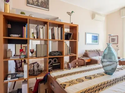 a living room with a vase on top of a bed at Bright Panorama Apartment in Rome