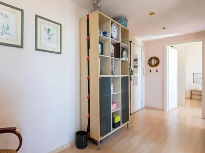 a living room with a book shelf in a room at Bright Panorama Apartment in Rome