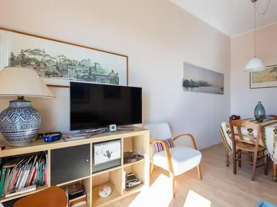 a living room with a flat screen tv on a entertainment center at Bright Panorama Apartment in Rome