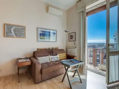 a living room with a couch and a view of a city at Bright Panorama Apartment in Rome