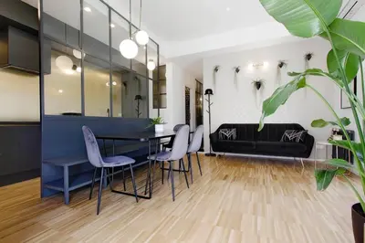 a living room with a table and chairs and a couch at YCH TRILOCALE FINEMENTE ARREDATO VICINO ALLA METRO in Rome