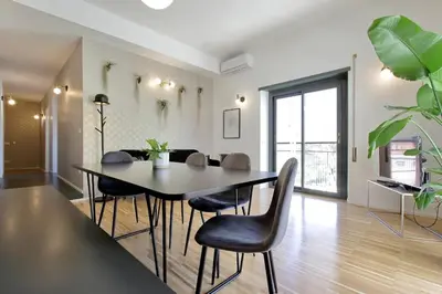 a dining room with a table and chairs at YCH TRILOCALE FINEMENTE ARREDATO VICINO ALLA METRO in Rome