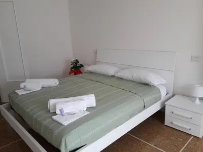 a bedroom with a bed with towels on it at La Piccoletta di Garbatella in Rome