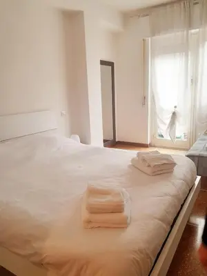 a white bed with two towels on top of it at La Piccoletta di Garbatella in Rome
