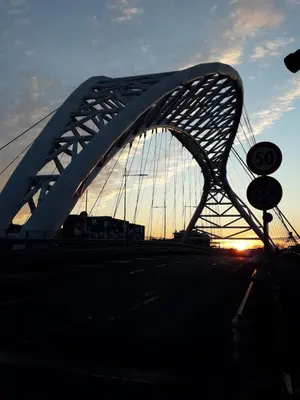 a bridge over a road with the sunset in the background at La Piccoletta di Garbatella in Rome