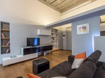 a living room with a couch and a flat screen tv at Luxury Fori Imperiali Flat in Rome